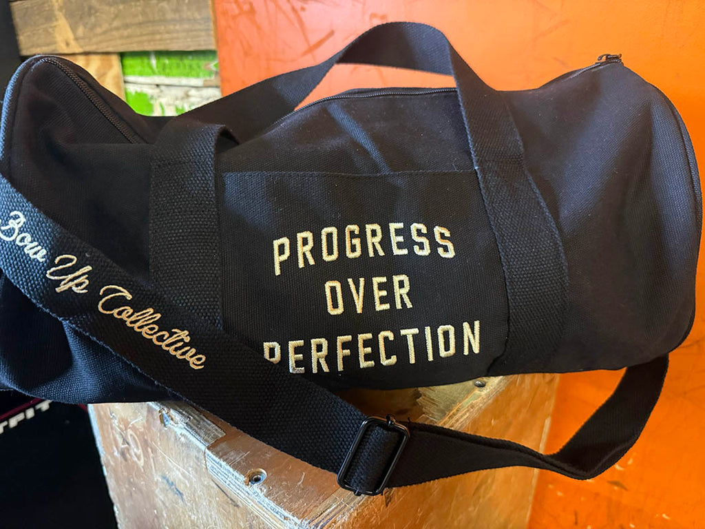 Progress over perfection duffel bag