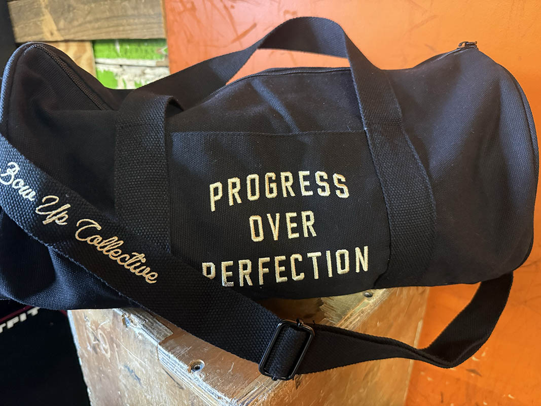Progress over perfection duffel bag